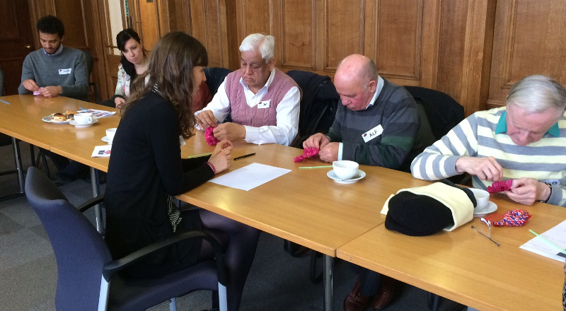 Members and volunteers making paper flowers