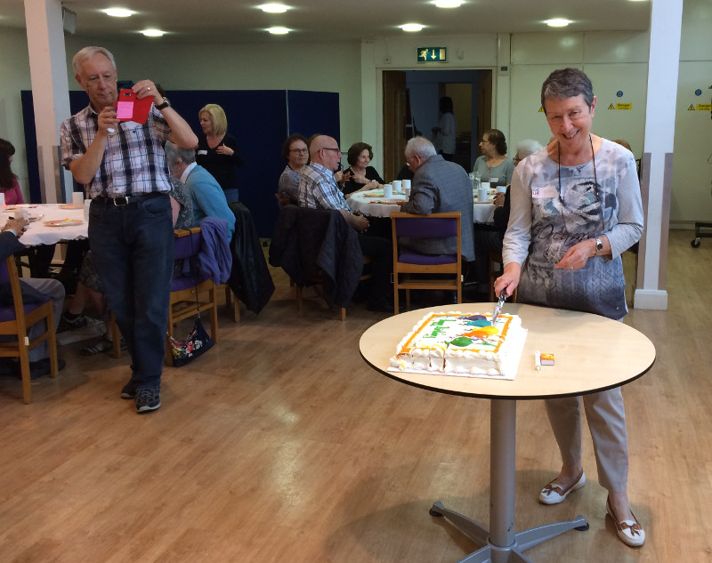 Gilda cutting her cake before sharing it out
