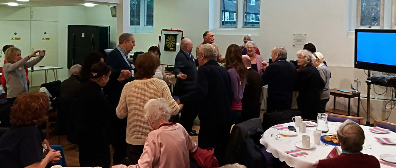 Members dancing the Hokey Cokey Members dancing the Hokey Cokey