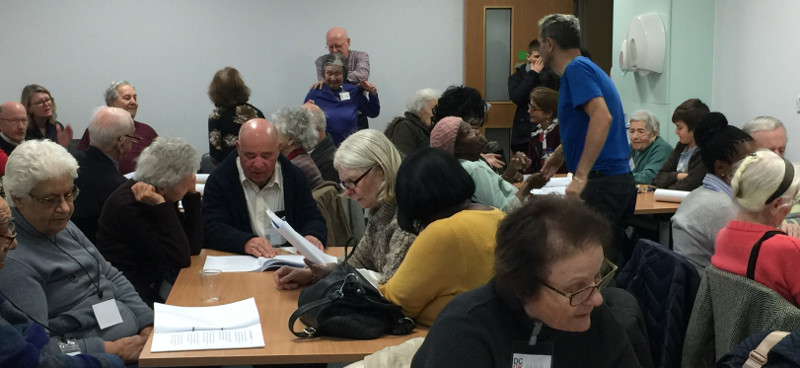 Eyes down for some singing, everyone is studying the song sheets Eyes down for some singing, everyone is studying the song sheets